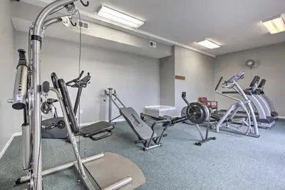 a gym with several exercise equipment in a room at Walk to Ocean Condo with Pool and Hot Tub in PCB! in Panama City Beach