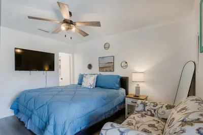 a bedroom with a bed and a ceiling fan at Beachside Bliss - Breakfast, Walk to Schooners, Sleeps 15, Fenced Privacy in Panama City Beach