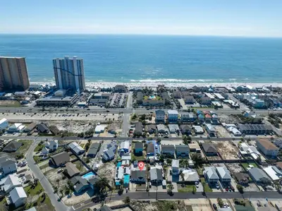 an aerial view of a parking lot next to the ocean at Beachside Bliss - Breakfast, Walk to Schooners, Sleeps 15, Fenced Privacy in Panama City Beach