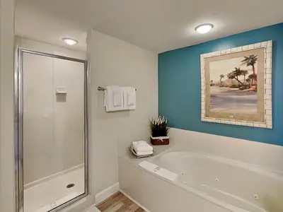 a bathroom with a shower and a bath tub at Grandview East #403 in Panama City Beach