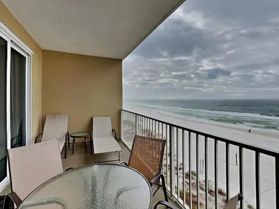 a balcony with chairs and a view of the beach at Grandview East #403 in Panama City Beach