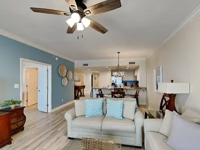 a living room with two couches and a ceiling fan at Grandview East #403 in Panama City Beach