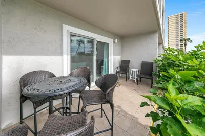 a patio with a table and chairs on a balcony at The Summit 126 in Panama City Beach