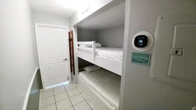 a small room with a bunk bed and a door at The Summit 126 in Panama City Beach