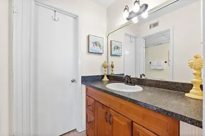 a bathroom with a sink and a mirror at Aquavista Condominiums #205-W by Book That Condo in Panama City Beach