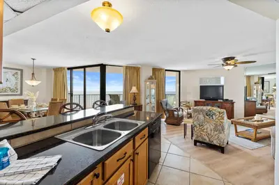 a kitchen with a sink and a living room at Aquavista Condominiums #205-W by Book That Condo in Panama City Beach