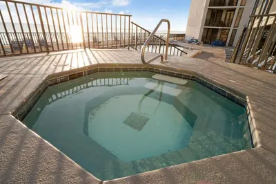 a swimming pool on a building with the sun shining at Aquavista Condominiums #205-W by Book That Condo in Panama City Beach