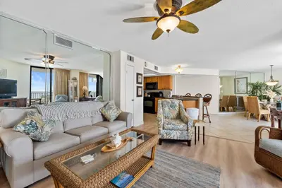 a living room with a couch and a table at Aquavista Condominiums #205-W by Book That Condo in Panama City Beach