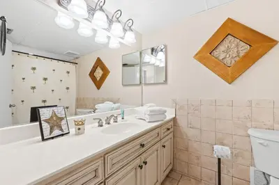 a bathroom with a sink and a mirror at Aquavista Condominiums #204-W by Book That Condo in Panama City Beach