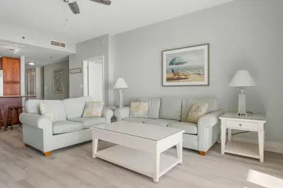 a living room with two couches and a coffee table at Laketown Wharf #1612 by Nautical Properties in Panama City Beach
