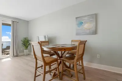 a dining room with a table and chairs at Laketown Wharf #1612 by Nautical Properties in Panama City Beach