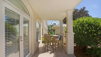 a balcony with a table and chairs on a house at Villas at Seagrove B101 in Santa Rosa Beach