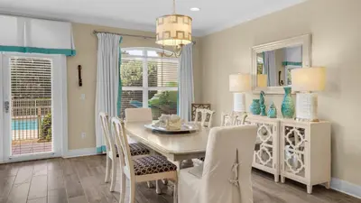 a dining room with a white table and chairs at Villas at Seagrove B101 in Santa Rosa Beach