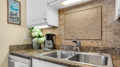 a kitchen with a sink and a counter top at Villas at Seagrove B101 in Santa Rosa Beach