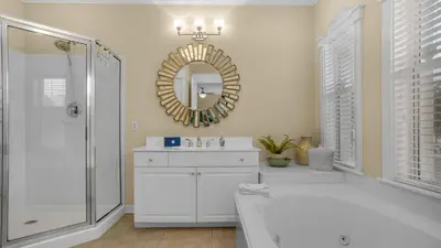 a white bathroom with a tub and a mirror at Villas at Seagrove B101 in Santa Rosa Beach