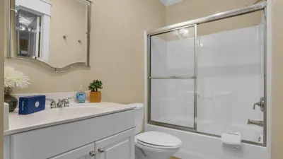 a white bathroom with a shower and a toilet at Villas at Seagrove B101 in Santa Rosa Beach