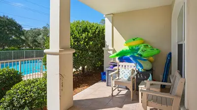a porch with chairs and a bunch of toys on it at Villas at Seagrove B101 in Santa Rosa Beach