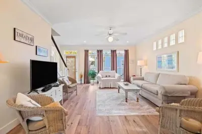 a living room with a couch and a tv at The Ocean Pearl in Santa Rosa Beach