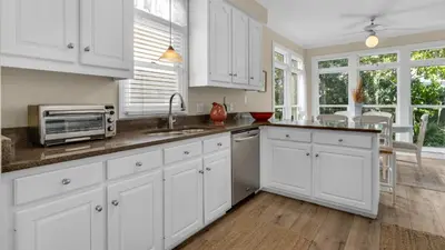 a white kitchen with a sink and a microwave at The Ocean Pearl in Santa Rosa Beach
