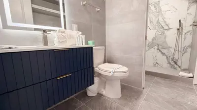a bathroom with a toilet and a sink and a shower at The Summit 518 in Panama City Beach