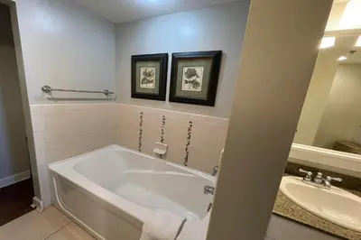 a bathroom with a bath tub and a sink at Grand Panama Beach Resort - The Grand #201 - Sunny Shores in Panama City Beach
