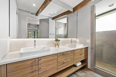 a bathroom with two sinks and a large mirror at NEW Listing! 4 BR/ 3.5 BA, SLEEPS 10, HEATED SALT WATER POOL in Seagrove Beach