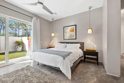 a bedroom with a bed and a large window at NEW Listing! 4 BR/ 3.5 BA, SLEEPS 10, HEATED SALT WATER POOL in Seagrove Beach