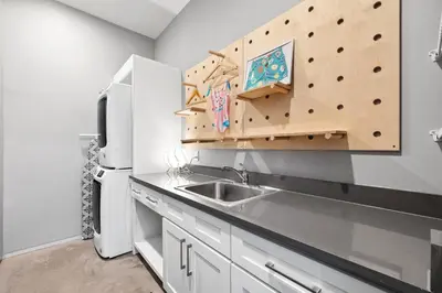 a kitchen with a sink and a climbing wall at NEW Listing! 4 BR/ 3.5 BA, SLEEPS 10, HEATED SALT WATER POOL in Seagrove Beach