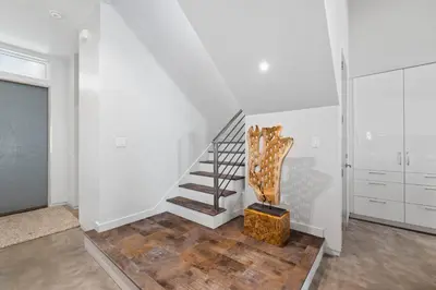 a staircase in a room with white walls and wooden floors at NEW Listing! 4 BR/ 3.5 BA, SLEEPS 10, HEATED SALT WATER POOL in Seagrove Beach