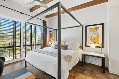 a bedroom with a canopy bed and large windows at NEW Listing! 4 BR/ 3.5 BA, SLEEPS 10, HEATED SALT WATER POOL in Seagrove Beach