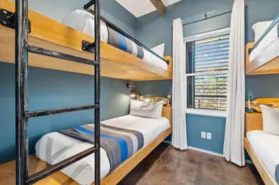 a bunk room with two bunk beds and a window at NEW Listing! 4 BR/ 3.5 BA, SLEEPS 10, HEATED SALT WATER POOL in Seagrove Beach