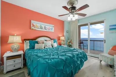 a bedroom with a bed and a ceiling fan at Once Upon A Tide in Panama City Beach
