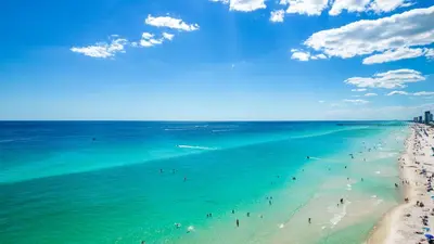 a group of people in the ocean on a beach at Once Upon A Tide in Panama City Beach
