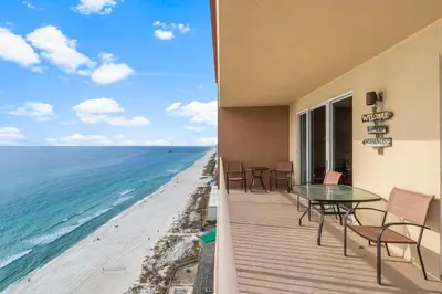 a balcony with a table and chairs and the ocean at Once Upon A Tide in Panama City Beach