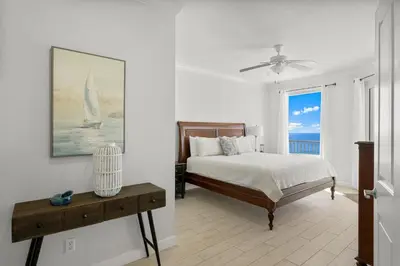 a bedroom with a bed and a view of the ocean at Spectacular 3BD Beachfront Condo! Spacious! by Dolce Vita Getaways PCB in Panama City Beach