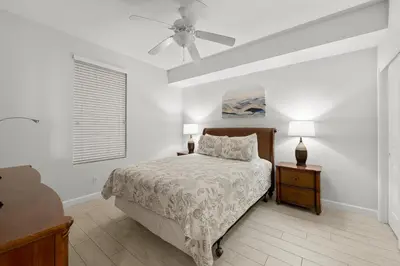 a bedroom with a bed and a ceiling fan at Spectacular 3BD Beachfront Condo! Spacious! by Dolce Vita Getaways PCB in Panama City Beach