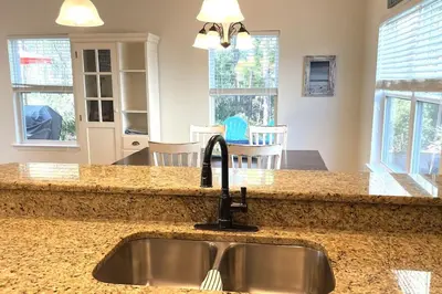 a kitchen with a sink and a counter top at Grayling Beach House in Inlet Beach