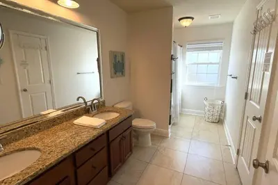 a bathroom with two sinks and a large mirror at Grayling Beach House in Inlet Beach