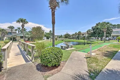 a park with a palm tree and a pathway at Walk to Beach and Restaurants PCB Resort Condo! in Panama City Beach