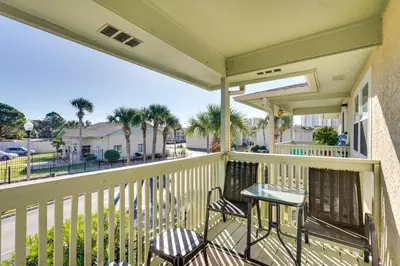 a balcony with two chairs and a table at Walk to Beach and Restaurants PCB Resort Condo! in Panama City Beach