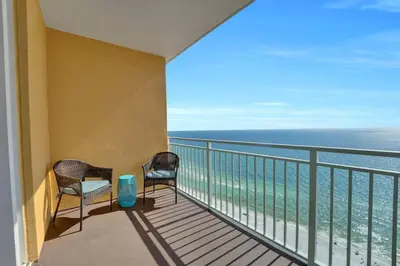 a balcony with two chairs and the ocean at Sterling Reef 1802B in Panama City Beach