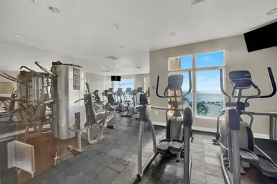 a gym with cardio equipment and a large window at Sterling Reef 1802B in Panama City Beach