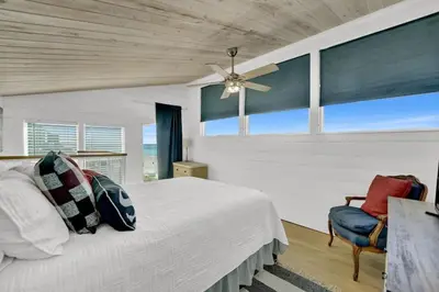 a bedroom with a bed and a ceiling fan at Luxury Top-Floor Gulf-View Condo w/ Bunkroom & Balcony in Panama City Beach