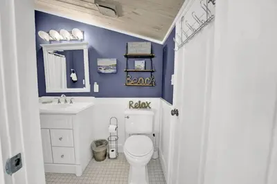 a bathroom with a toilet and a sink at Luxury Top-Floor Gulf-View Condo w/ Bunkroom & Balcony in Panama City Beach