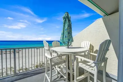 a table and chairs on a balcony overlooking the ocean at Luxury Top-Floor Gulf-View Condo w/ Bunkroom & Balcony in Panama City Beach