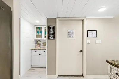 a kitchen with white walls and a white door at 3BR, 3BA beachfront townhome! Sleeps 11! Ocean view! Steps to the beach! in Panama City Beach