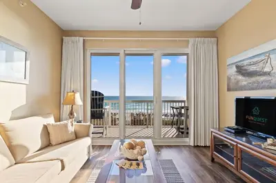 a living room with a couch and a view of the ocean at Seychelles 205 in Panama City Beach