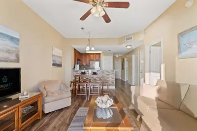 a living room with a couch and a ceiling fan at Seychelles 205 in Panama City Beach