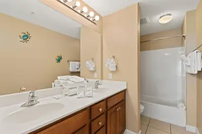 a bathroom with a white sink and a shower at Seychelles 205 in Panama City Beach
