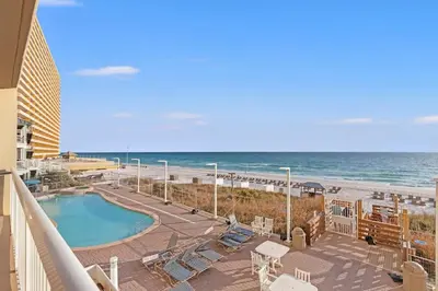 a balcony with a swimming pool and the beach at Seychelles 205 in Panama City Beach
